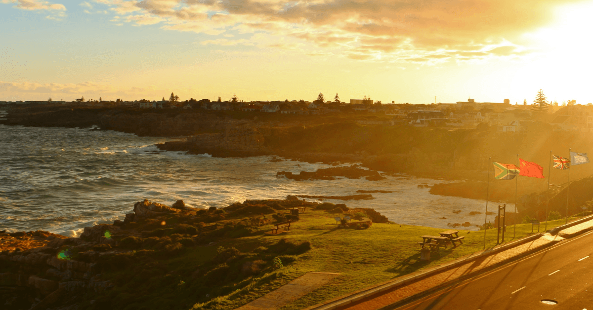 Coastal sunset over Walker Bay with Rocky shoreline , ocean waves and a seaside viewpoint in Hermanus 